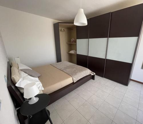 a small bedroom with a bed and a chair at A casa di Any in Cascina