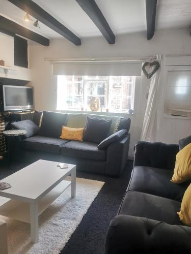a living room with a couch and a coffee table at Lavender Cottage in Yarm