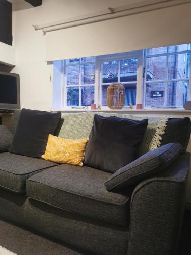 a couch with pillows on it in a living room at Lavender Cottage in Yarm