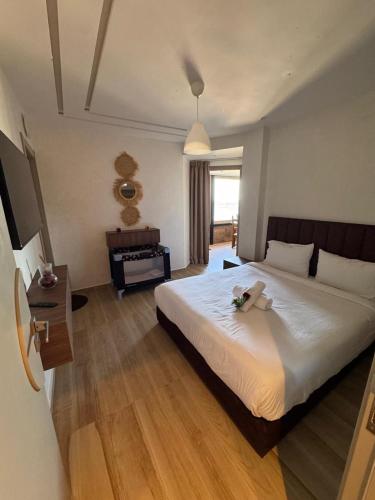 a bedroom with a large white bed with flowers on it at Casa de Marinero in Martil