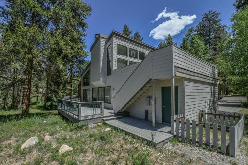 a house with a porch and a fence at Keystone Bristlecone Home 31 by SummitCove Lodging in Colorado in Keystone