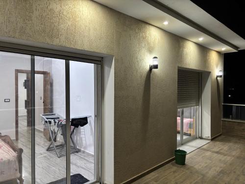 a living room with a table and glass doors at Appartement vue mer 200m in Rejiche
