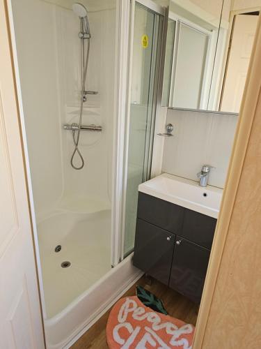 a bathroom with a shower and a sink at Bella in Skegness