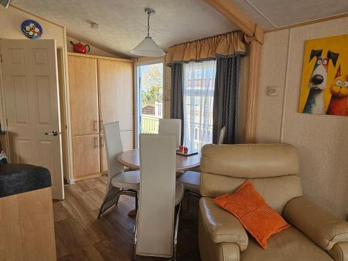a small living room with a table and a couch at Bella in Skegness
