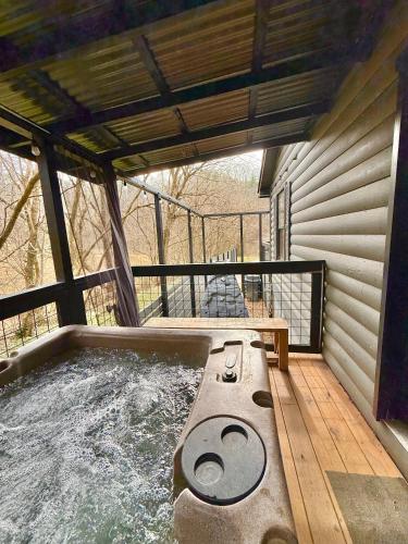 a hot tub on the deck of a house at Charming vacation nest in Sevierville