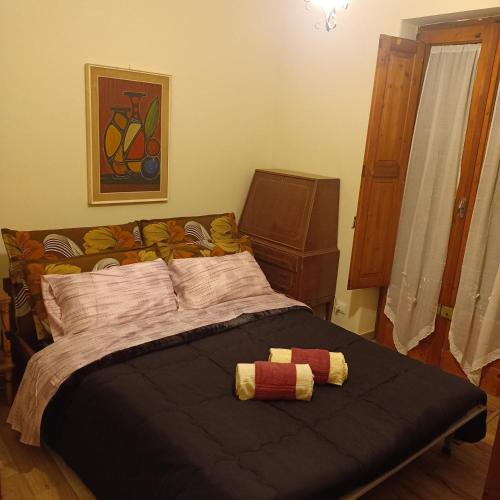 a bedroom with a bed with two stuffed animals on it at Cottage Etna nel Cuore in Nicolosi