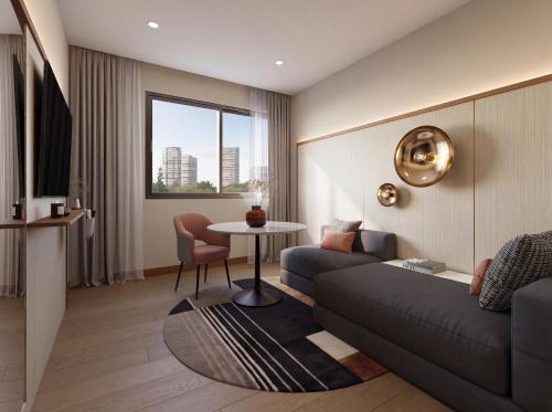 a living room with a couch and a table at The Sebel Parramatta in Sydney