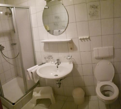 a bathroom with a sink and a toilet and a mirror at Apartmenthaus Immler in Gaschurn