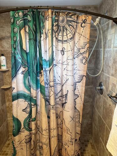 a shower curtain with a painting of a forest at LasPalmas Beach Rentals,3 in Bradenton Beach