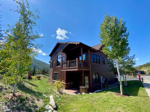 a house on a hill with trees in front of it at Frey Gulch 46 by SummitCove Lodging in Colorado in Keystone