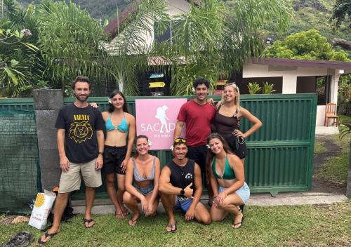a group of people posing for a picture in front of a fence at Sacado Moorea Auberge de jeunesse Youth Hostel non climatisé no AC in Irioa