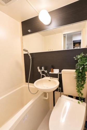 a bathroom with a toilet and a sink at Hachioji House 102 Apartment in Hachioji