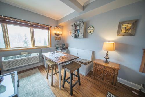 a room with a table and two chairs and a desk at Gateway Lodge 5084 by SummitCove Lodging in Colorado in Keystone