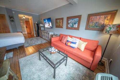 a living room with a couch and a table at Gateway Lodge 5084 by SummitCove Lodging in Colorado in Keystone
