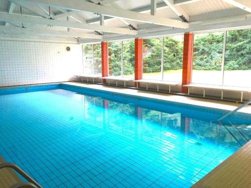 a large swimming pool with blue water at WaldLoft in Todtmoos