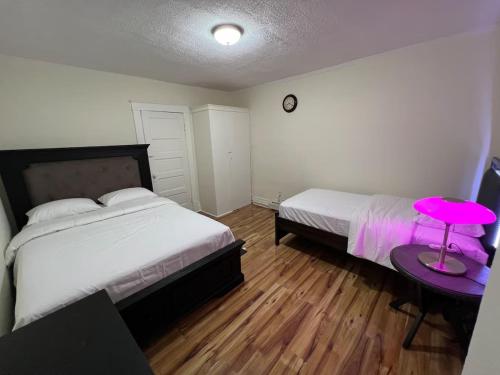 a bedroom with two beds and a pink table at Spacious 3BR Niagara Stay + Backyard in Niagara Falls