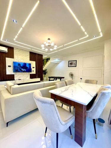 a living room with a table and chairs and a couch at Prince-Coll apartment in Lagos