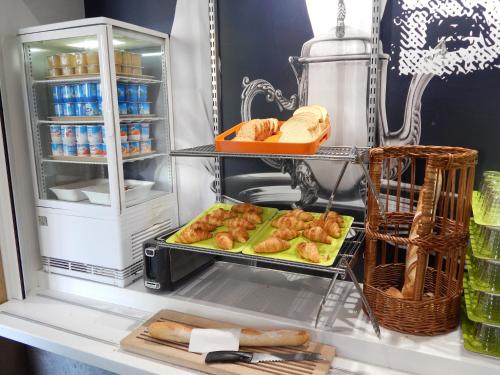 an open refrigerator with bread and pastries in it at ibis budget Limoges Centre Gare in Limoges