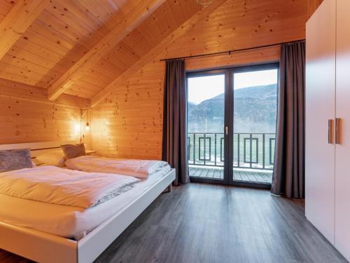 a bedroom with a bed and a large window at Rattendorf 11B in Rattendorf