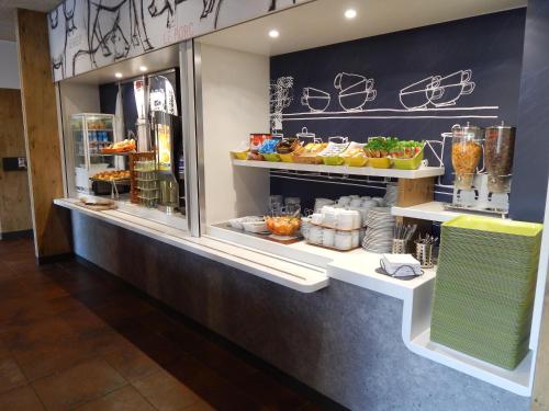 a food counter in a restaurant with food on display at ibis budget Limoges Centre Gare in Limoges