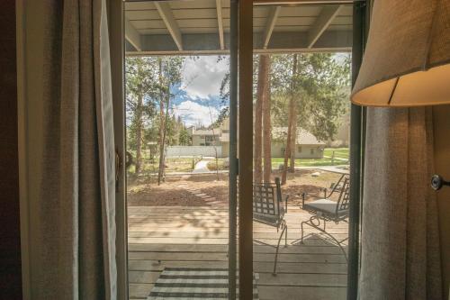 a sliding glass door leading to a patio with a chair at Flying Dutchman 1115 by SummitCove Lodging in Colorado in Keystone