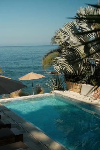 a swimming pool with a view of the ocean at La Joya Sayulita in Sayulita