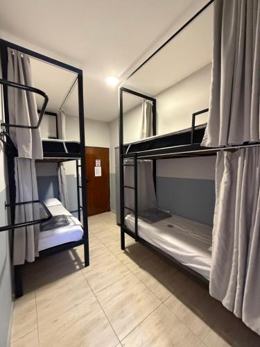 a room with two bunk beds in a room at São Hostel in São Roque
