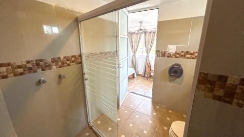 a bathroom with a shower and a toilet at Casa ka'an in Isla Mujeres