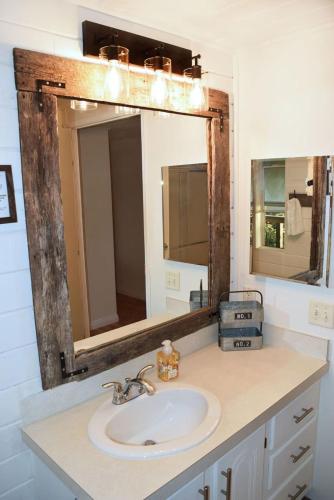 a bathroom with a sink and a mirror at The Tack Room in Naples