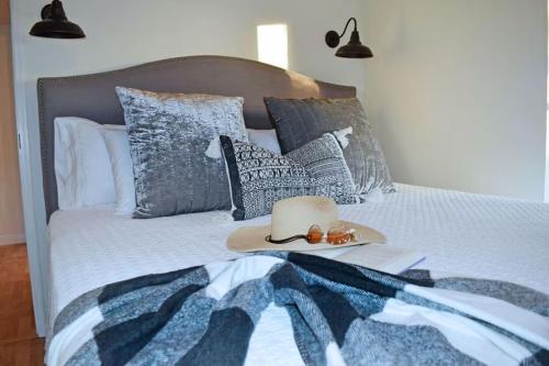 a bed with a hat and fruit on it at The Tack Room in Naples