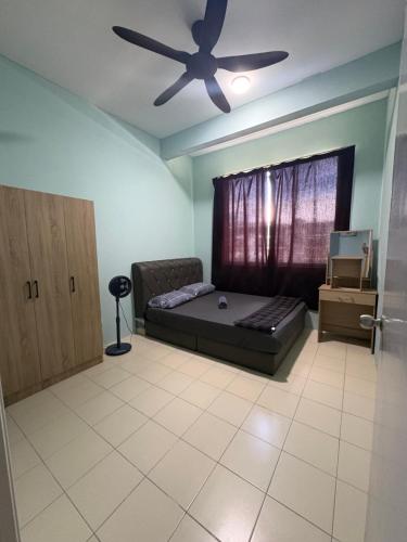 a bedroom with a bed and a ceiling fan at Aileen Homestay in Tawau
