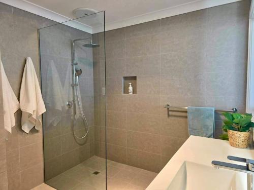a shower with a glass door in a bathroom at Cygnet Escape in Cygnet River