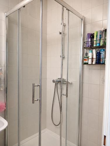 a shower with a glass door in a bathroom at StaySpace in Graz