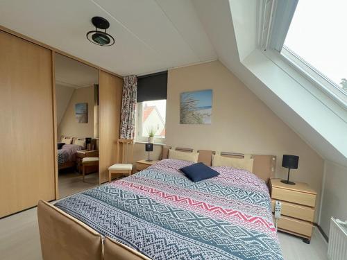 a bedroom with a large bed in a attic at Park De Markol Tureluur 13 in Lemmer