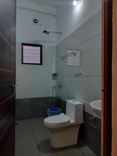 a bathroom with a toilet and a sink at Asprin Homestay in Munnar