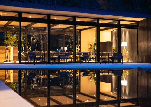 a house with a swimming pool at night at Hotel MODA in Yufu