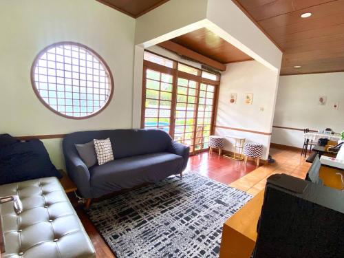 a living room with a couch and a table at SF Homey Yokohama in Cikundul