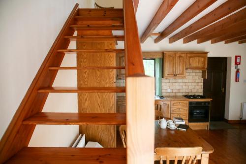 a wooden staircase in a room with a kitchen at Killeena House in Baltimore