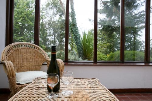 a table with a bottle of wine and two glasses at Killeena House in Baltimore