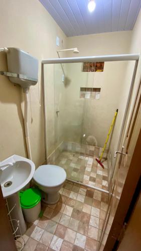 a bathroom with a shower with a toilet and a sink at Sítio Relax in Tianguá