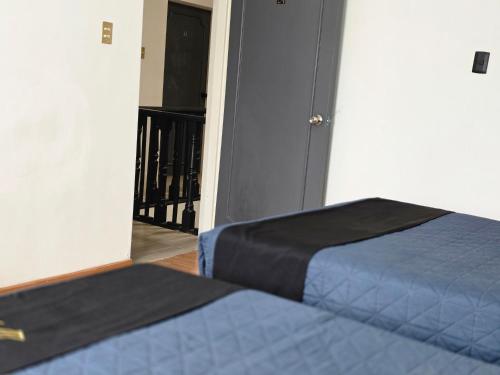 a bedroom with two beds and a door with a balcony at 25 Habitación doble cama in Miravalle