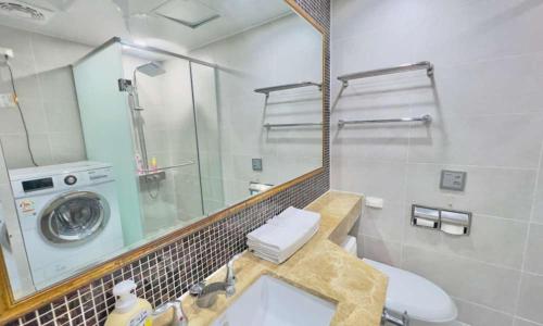 a bathroom with a sink and a washing machine at Busan Centum Victoria hotel in Busan