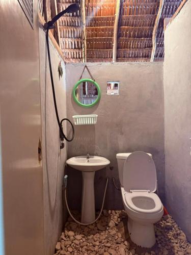 a small bathroom with a toilet and a sink at Warahnus dive homestay in Kri