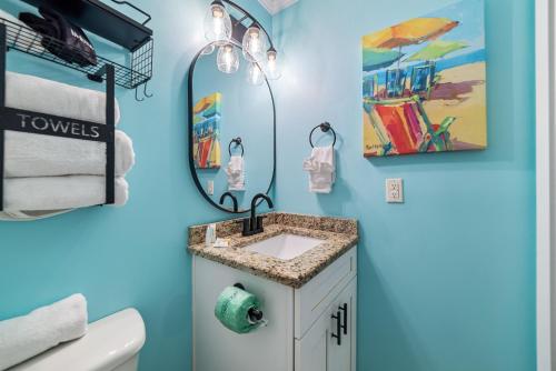 a bathroom with a sink and a mirror at BeachFront, Bottom Level Condo at Tradewinds in Orange Beach