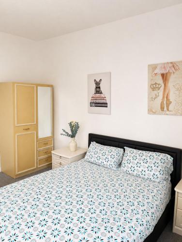 a bedroom with a bed and a dresser and a mirror at Stylish Room in Wolverhampton opp Asda in Wolverhampton