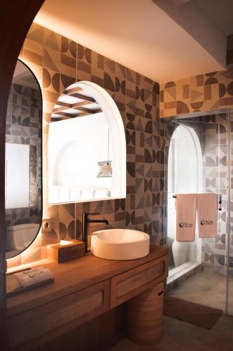 a bathroom with a sink and a mirror at The Casa Lunamoon in Kintamani