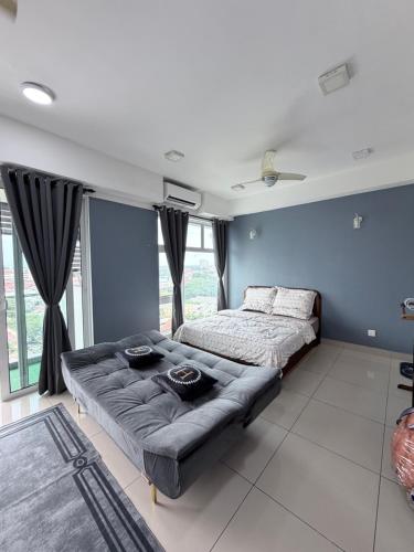 a bedroom with a bed and a couch at Ezae Studio D'Perdana Apartment in Kota Bharu