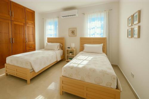 two beds in a room with at Luxury Comfort Villa in Punta Cana