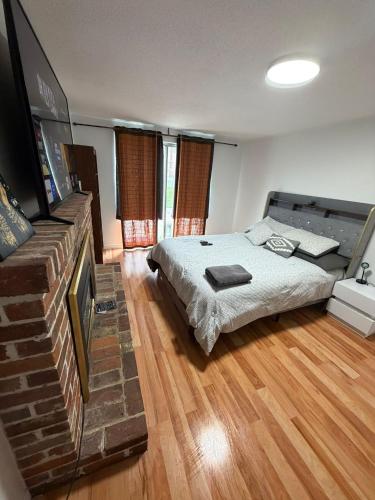 a bedroom with a bed and a flat screen tv at Luxury Fun Villa in Toronto