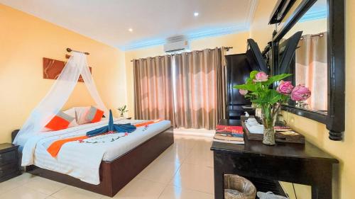 a bedroom with a bed and a window with a dresser at Harmony Hotel in Siem Reap